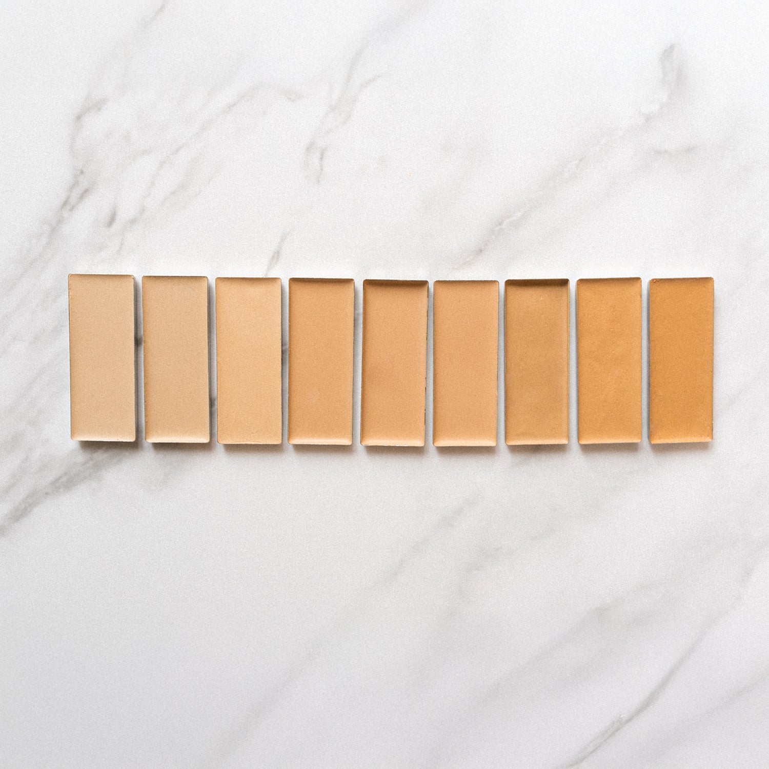 Line up of varying shades of foundation tins