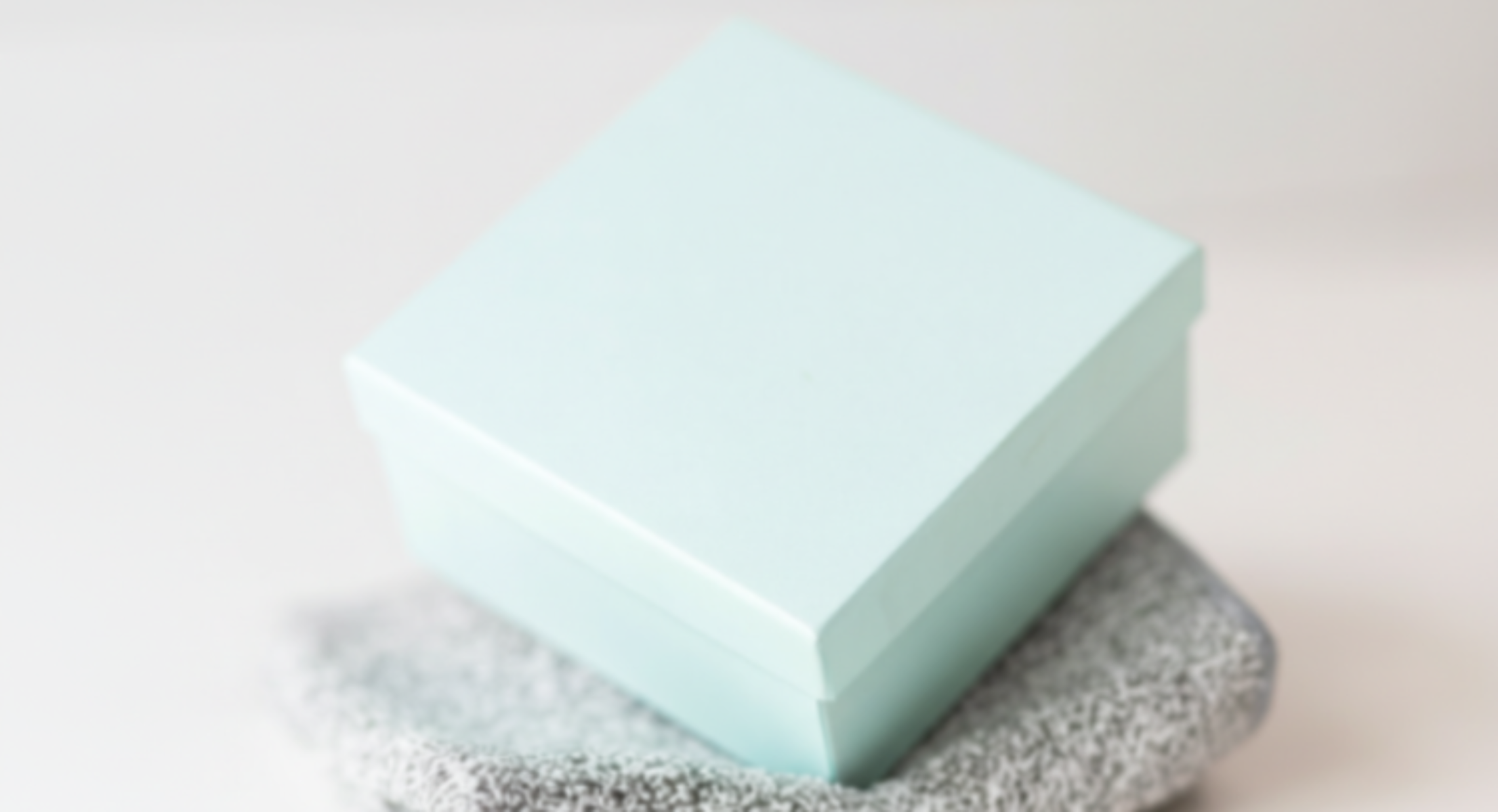 Light blue box on a textured makeup remover cloth with a blurred background