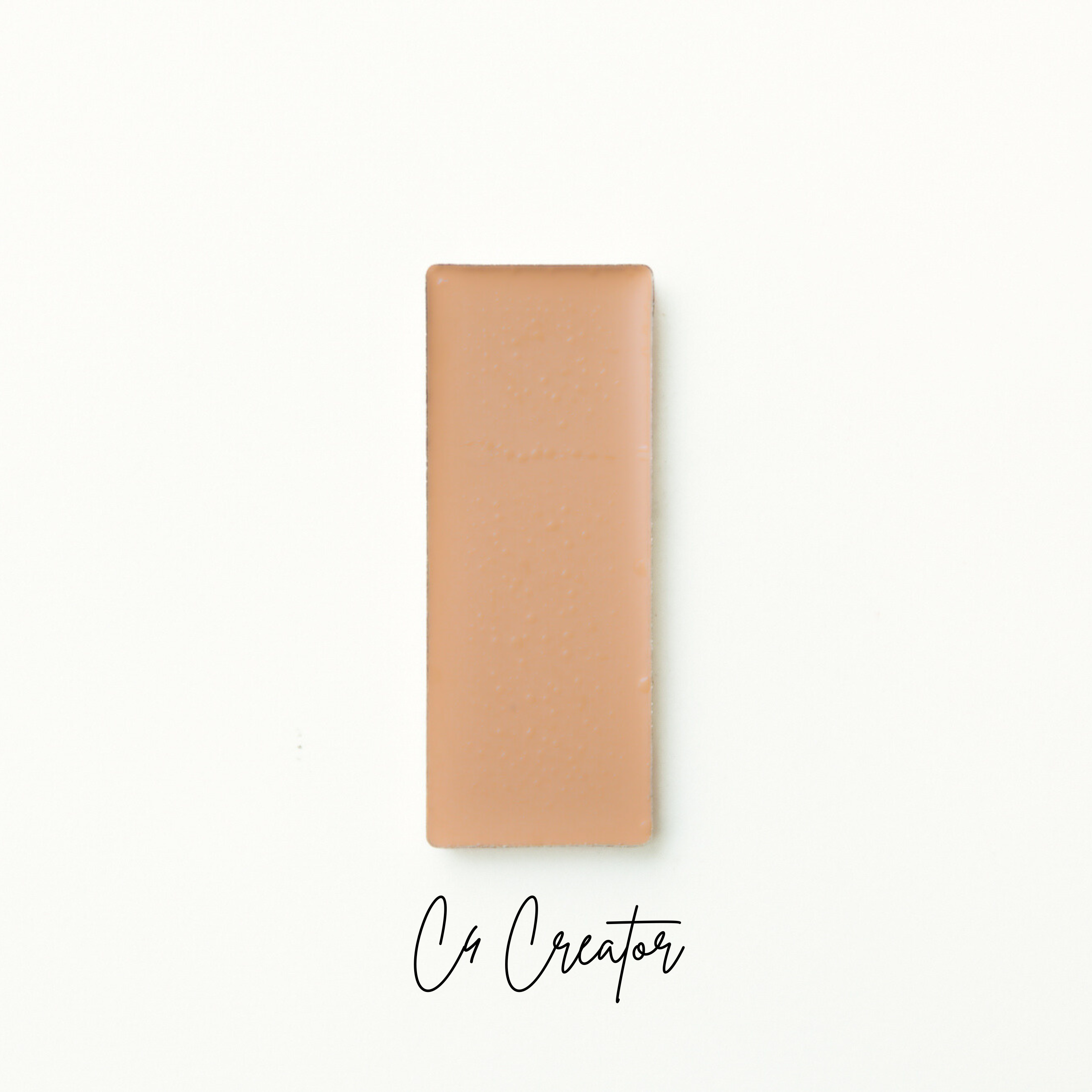 Rectangular brown object on a white background with 'Co Creator' text. natural foundation
