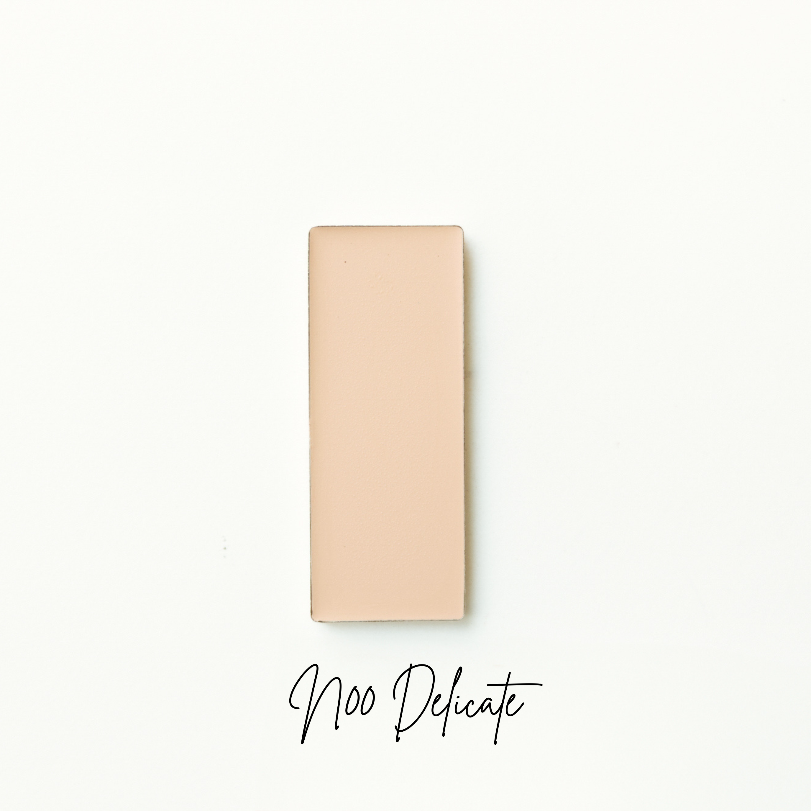 Beige rectangular product on a white background with 'Noo Delicate' text. Natural foundation